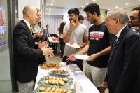 Prof Tjonnie LI (first from left), Member of the Committee on College Life, introducing some Dutch snacks to the College students